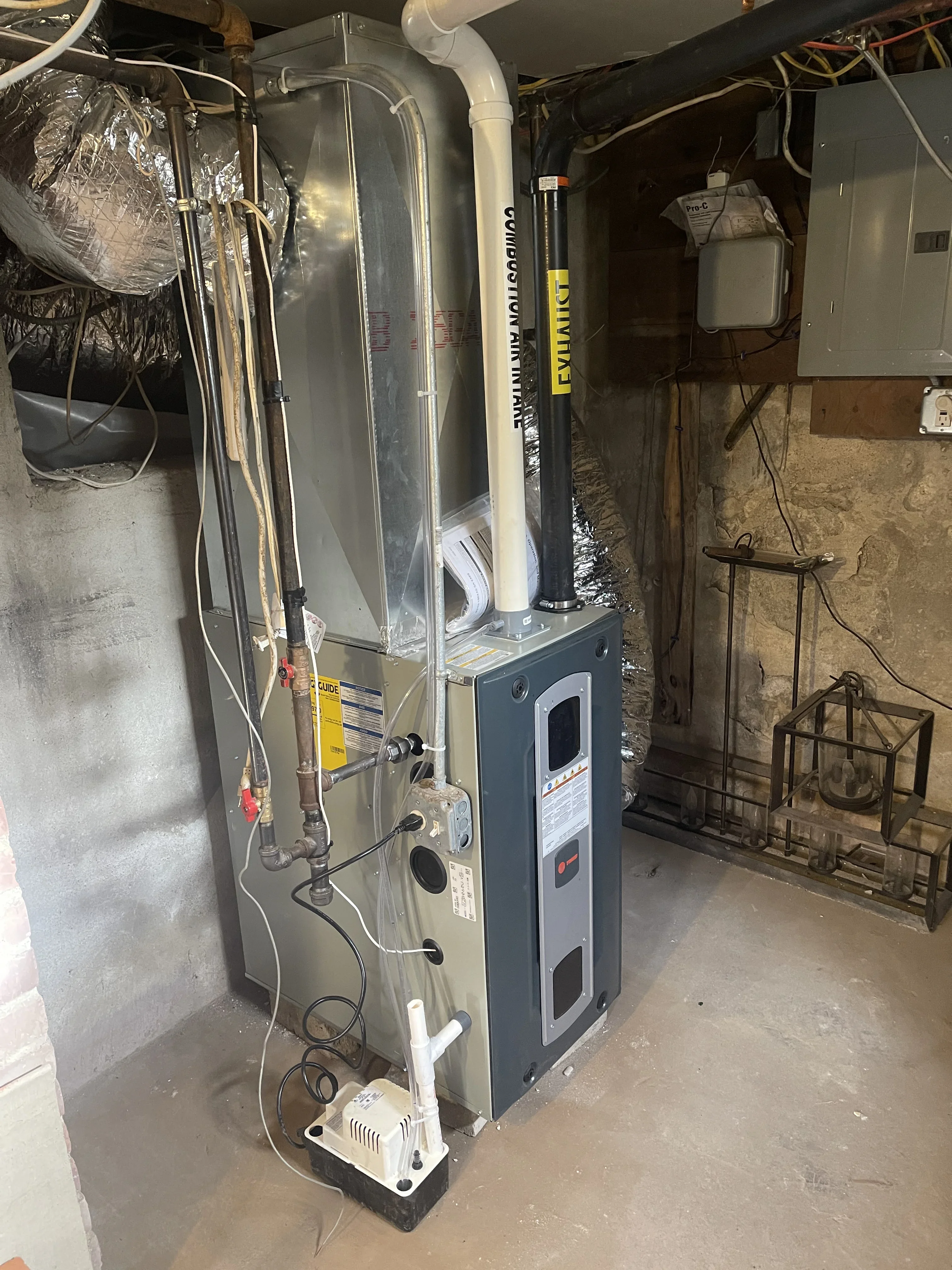 New Lennox furnace with PVC venting, ductwork, and condensate pump installation in basement