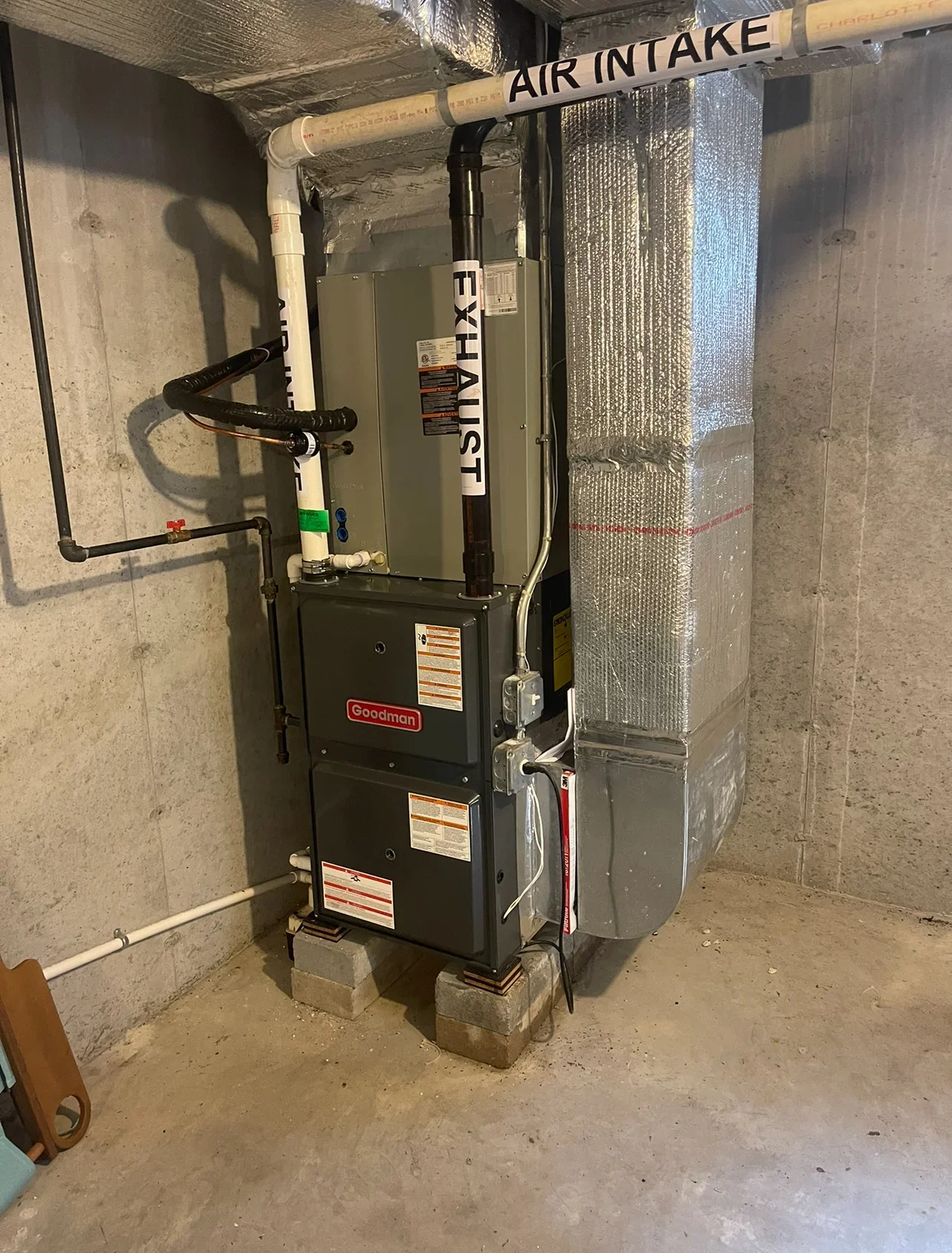 Goodman furnace and Lennox air handler with ductwork and insulation in basement