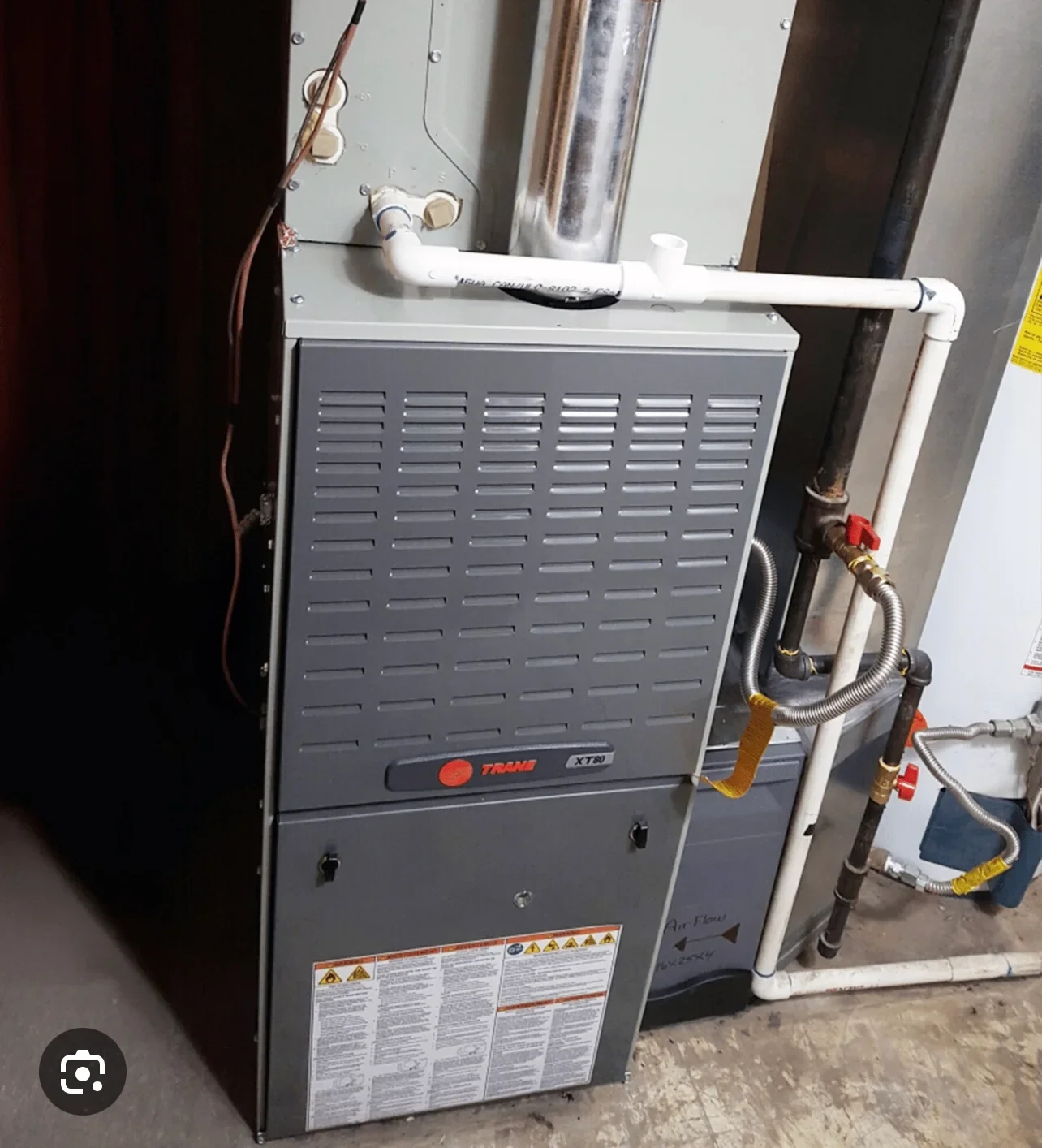 Trane XR8 furnace with white PVC ductwork, copper refrigerant lines, and brass isolation valves installed